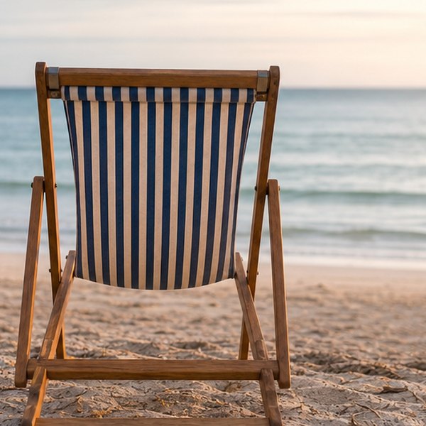 Empty beach chair facing ocean — detail